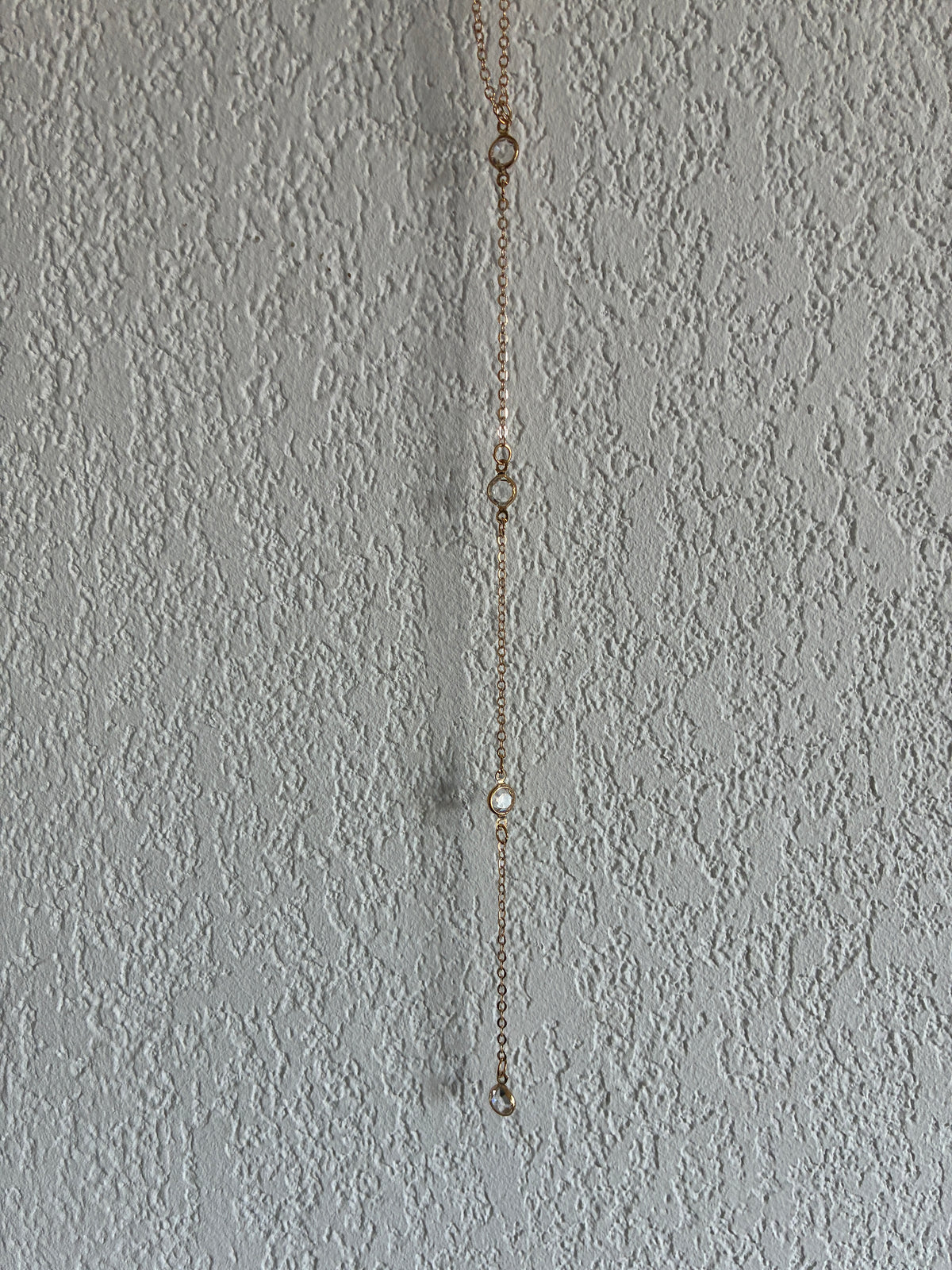 Collier de dos doré 4 strass