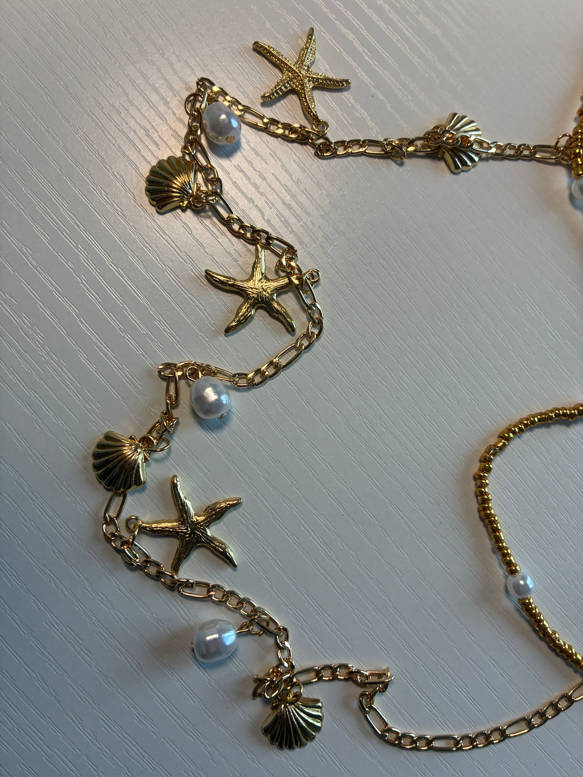Chaîne de taille dorée coquillages, étoiles de mer et perles